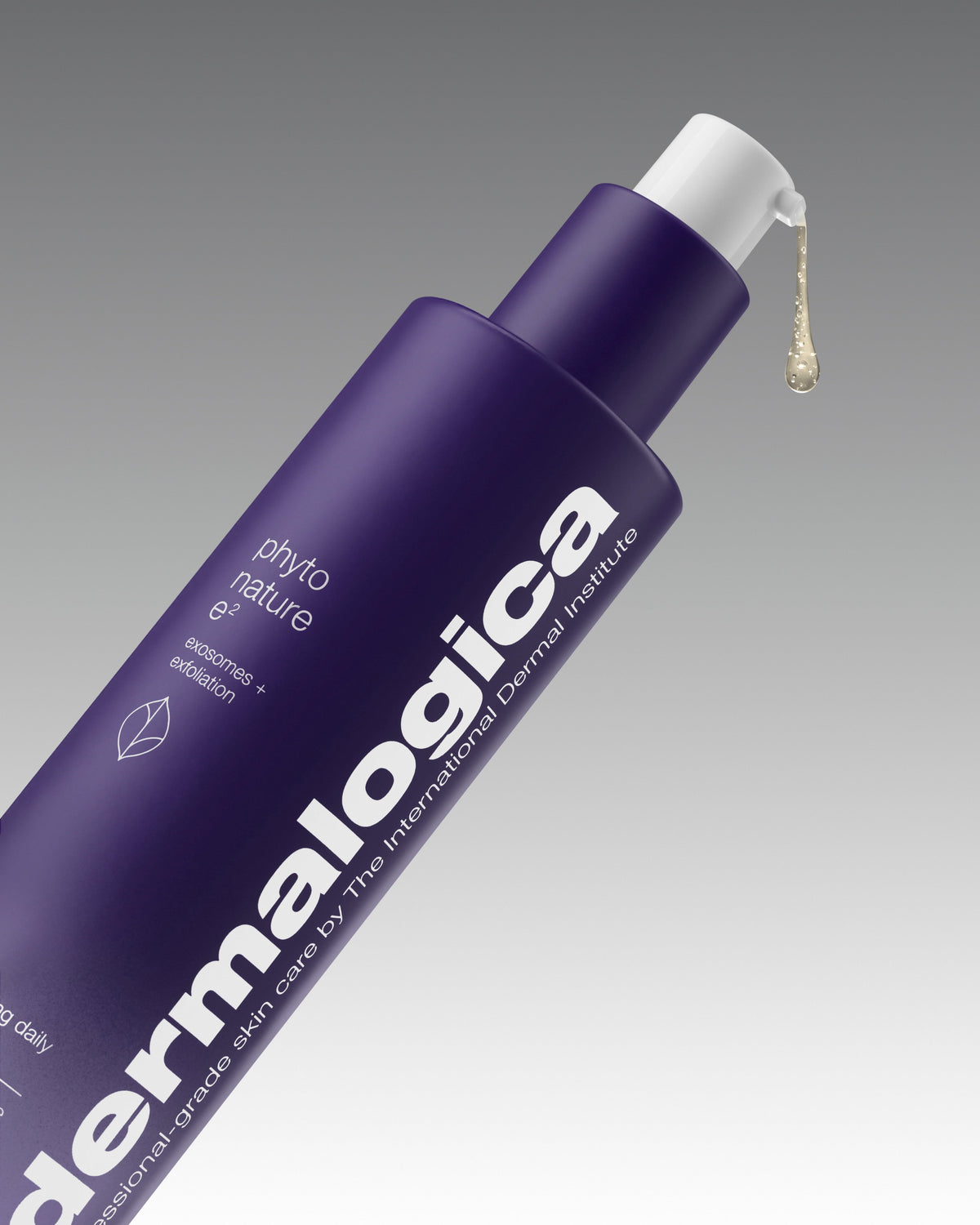 Purple Dermalogica Phyto Nature e² bottle angled on a grey gradient background, with a drop of serum dispensing from the pump. Text on bottle reads “exosomes + exfoliation”.